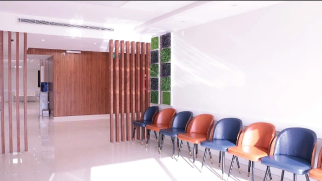 Seating area inside Bait AlTeeb Medical, with rows of chairs and wooden partitions